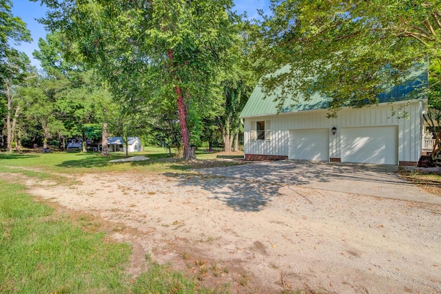 481 Cantey Ln, Camden, SC 29020 - view of green lawn featuring a garage and concrete driveway