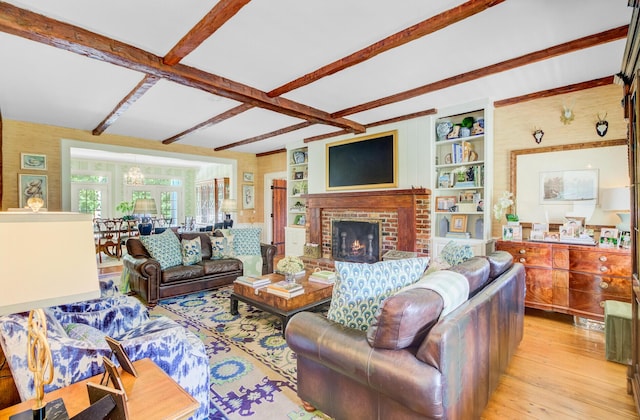 481 Cantey Ln, Camden, SC 29020 - living room with beamed ceiling, light wood finished floors, a brick fireplace, and a chandelier