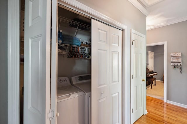 2329 Tall Sail Dr Unit 704D, Charleston, SC 29414 - laundry room with ornamental molding, washer and clothes dryer, and light wood-style flooring