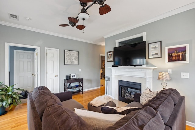 2329 Tall Sail Dr Unit 704D, Charleston, SC 29414 - living room featuring a ceiling fan, ornamental molding, wood finished floors, and a fireplace