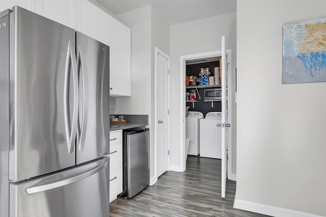 kitchen featuring washer and clothes dryer, white cabinetry, stainless steel appliances, and dark wood-type flooring