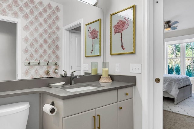 bathroom with ceiling fan, vanity, and toilet