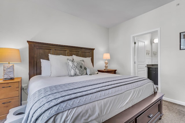 bedroom featuring light colored carpet and connected bathroom