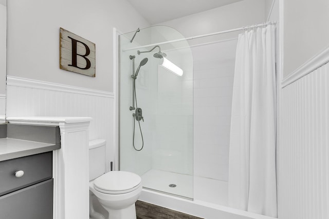 bathroom featuring a shower with curtain, hardwood / wood-style flooring, and toilet