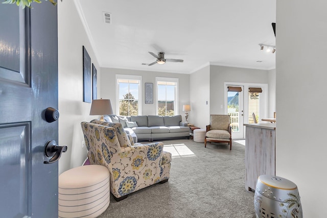 living room with carpet, plenty of natural light, ceiling fan, and french doors