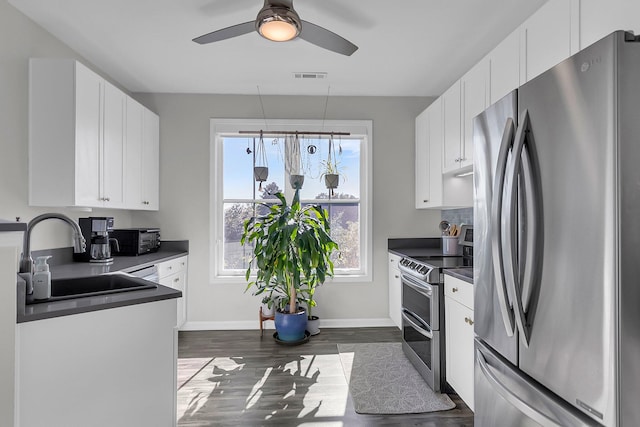 kitchen with white cabinets, dark hardwood / wood-style floors, sink, and appliances with stainless steel finishes