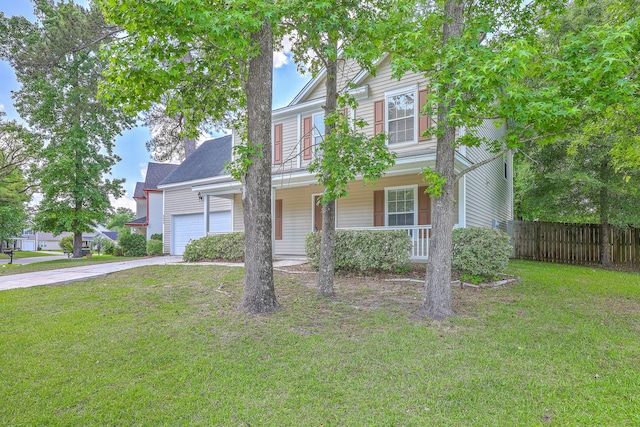 view of front of property with covered porch, fence, concrete driveway, and a front yard