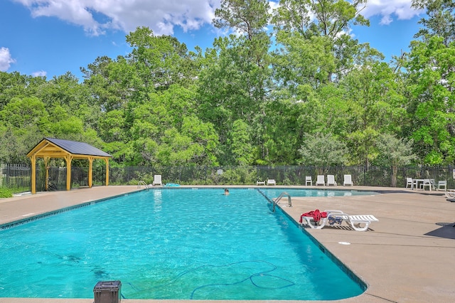 pool with fence and a gazebo