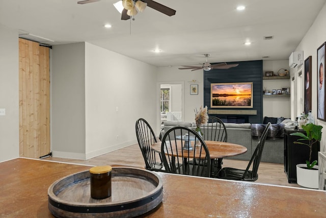 dining space featuring recessed lighting, a ceiling fan, baseboards, visible vents, and a wall mounted air conditioner