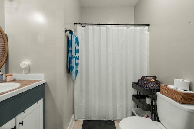 bathroom featuring toilet and vanity