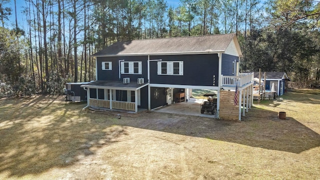 view of front of house with a sunroom, stairs, dirt driveway, and a carport