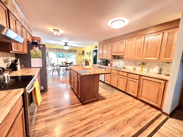 1325 Edward Dr, Moncks Corner, SC 29461 - kitchen featuring butcher block counters, stainless steel appliances, light wood-style floors, and backsplash
