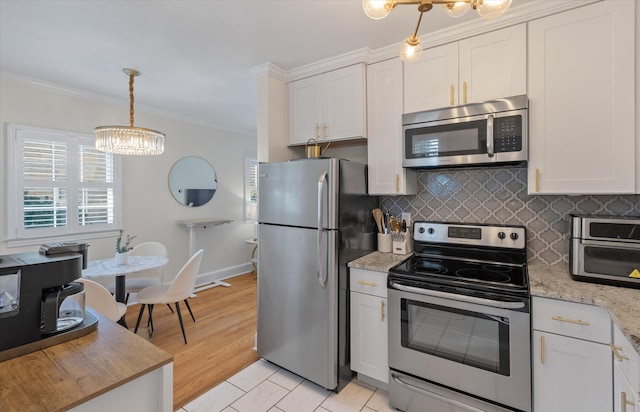 kitchen with a chandelier, appliances with stainless steel finishes, light hardwood / wood-style floors, and white cabinetry