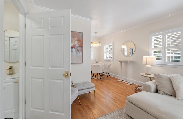 living room with a chandelier, crown molding, and wood-type flooring