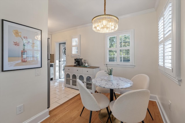 dining room with a wealth of natural light, crown molding, and light wood-type flooring