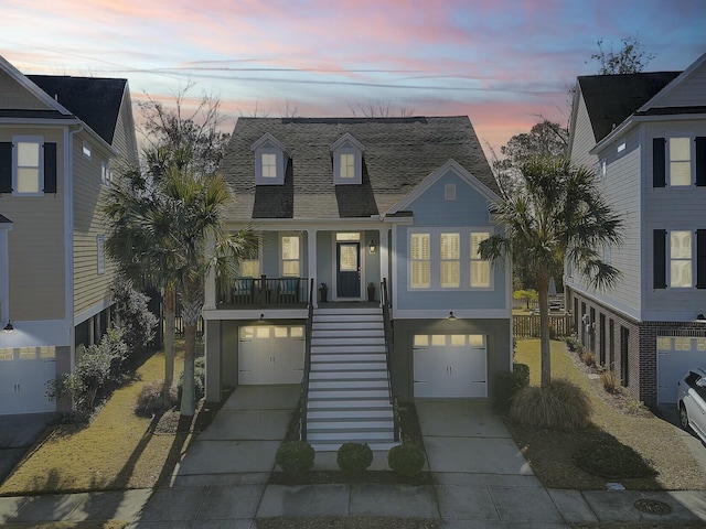 coastal home featuring a garage and covered porch