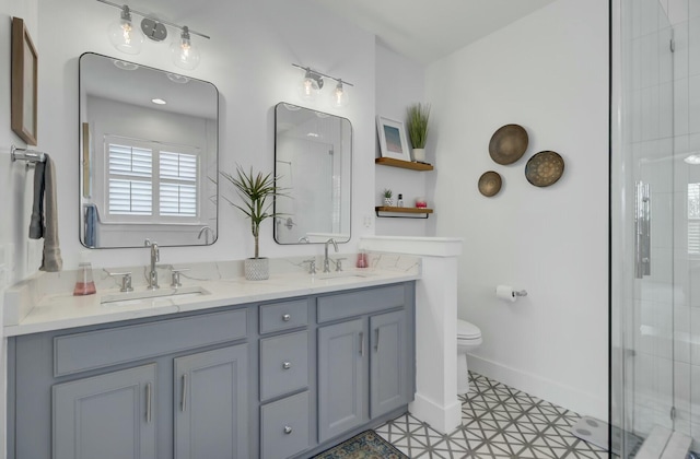 bathroom with vanity, toilet, and a shower with shower door