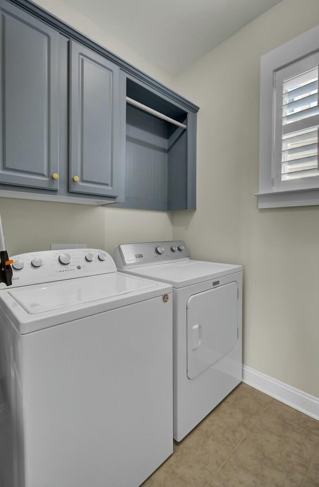 washroom featuring cabinets and washer and dryer