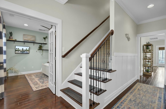 staircase featuring crown molding and wood-type flooring