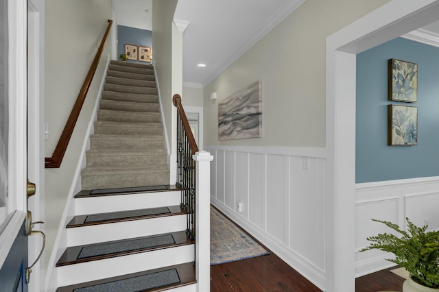 stairs featuring crown molding and hardwood / wood-style flooring