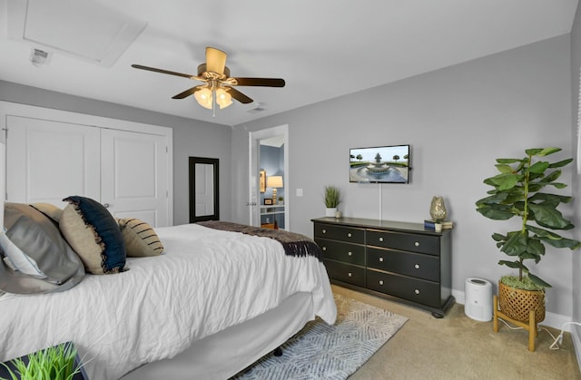 bedroom featuring light carpet, a closet, and ceiling fan