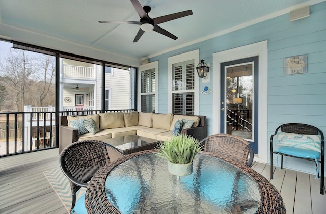 sunroom / solarium featuring ceiling fan