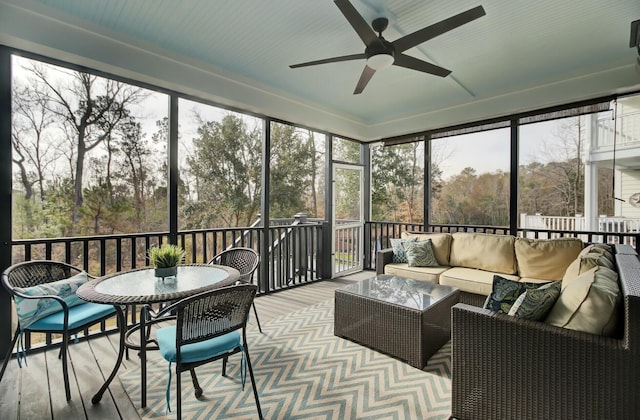 sunroom featuring plenty of natural light and ceiling fan