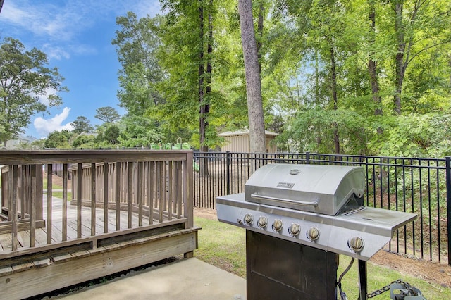 view of patio featuring a grill and a deck