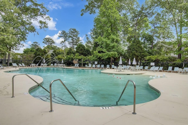 view of pool with a patio and pool water feature