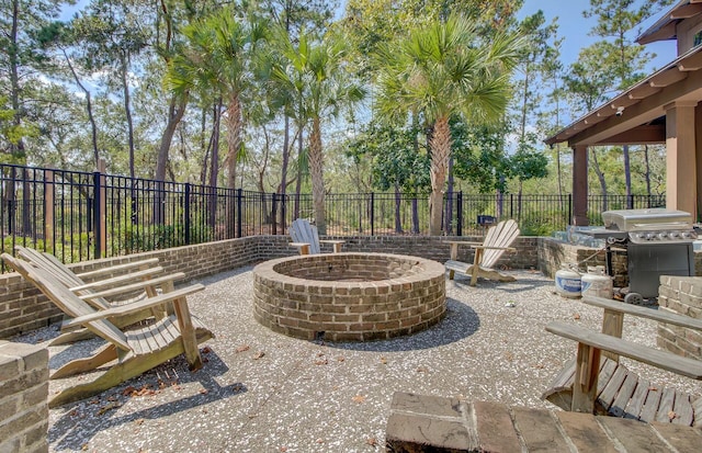 view of patio featuring area for grilling and a fire pit