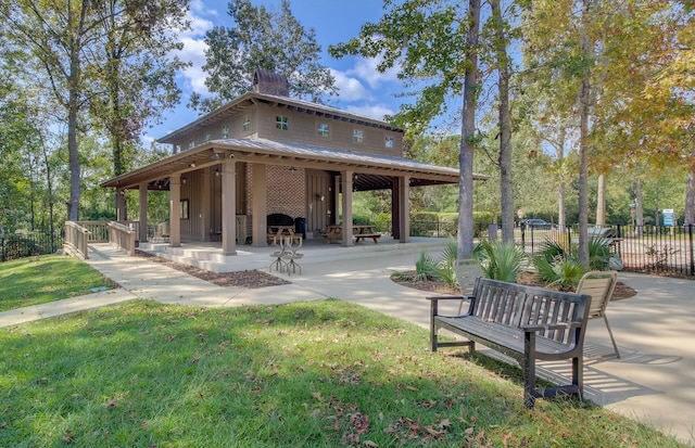 view of home's community with a gazebo, a patio, and a lawn