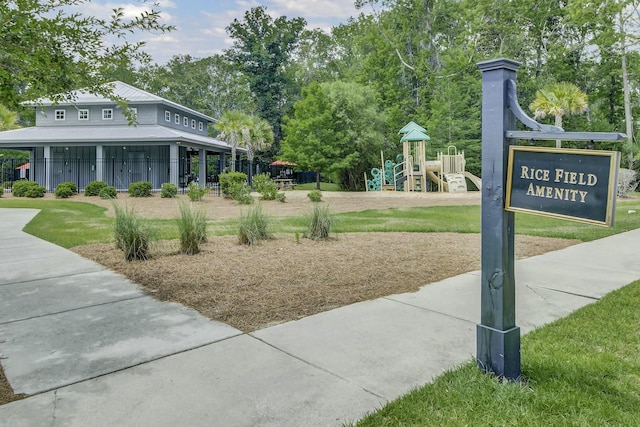 view of community featuring a playground and a lawn