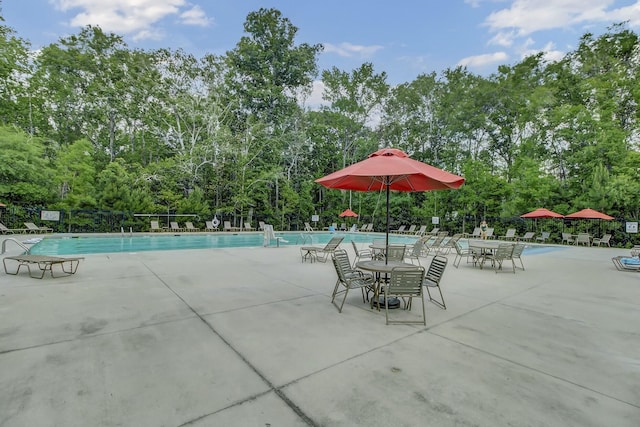 view of swimming pool featuring a patio area