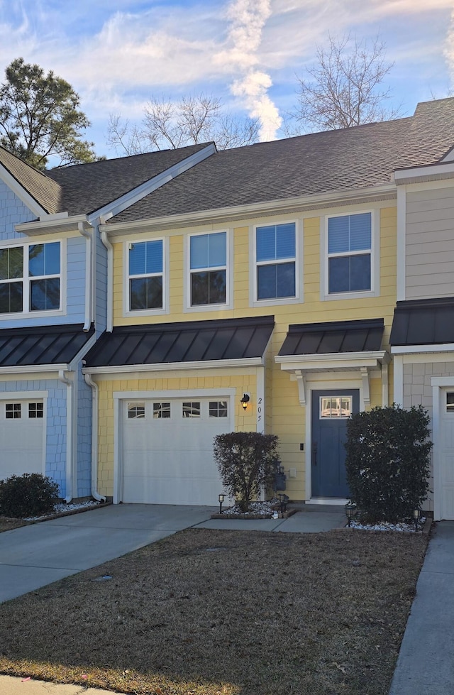 townhome / multi-family property with concrete driveway, metal roof, roof with shingles, an attached garage, and a standing seam roof