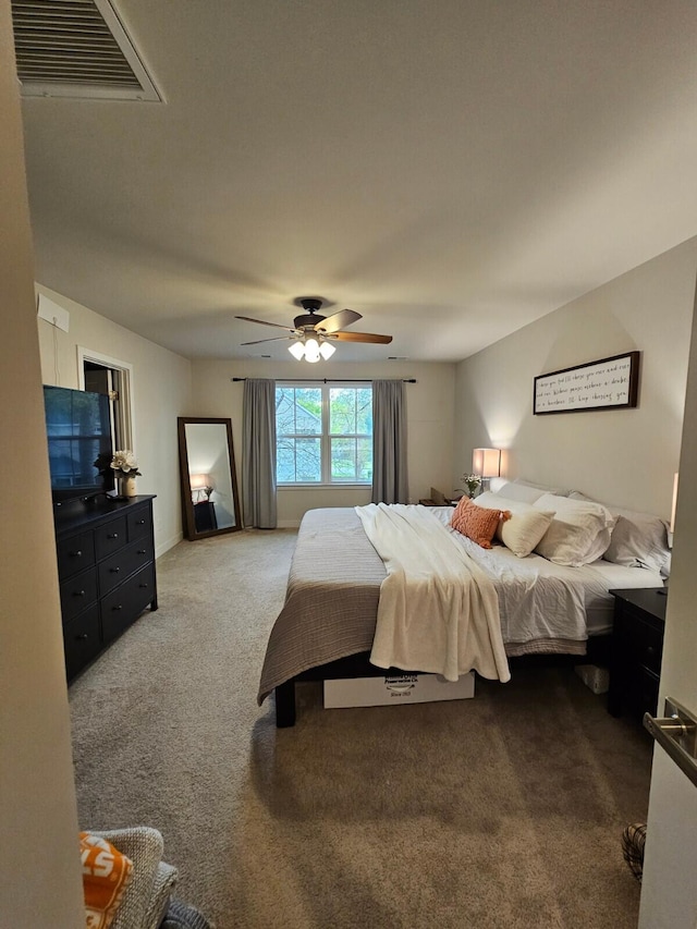 carpeted bedroom featuring a ceiling fan and visible vents