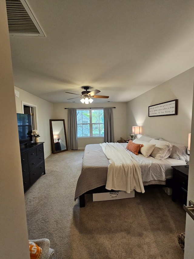 bedroom with carpet, visible vents, and ceiling fan