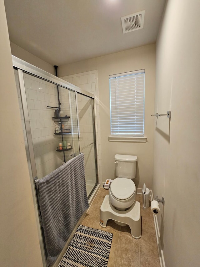 full bath with toilet, a stall shower, tile patterned flooring, and visible vents