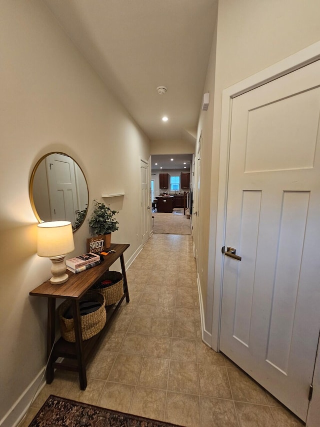 corridor with recessed lighting, baseboards, and tile patterned floors