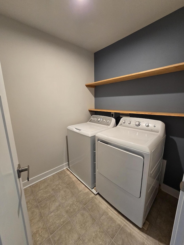 laundry room featuring washing machine and dryer, laundry area, tile patterned flooring, and baseboards