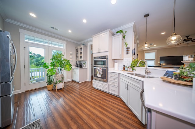 1726 Winfield Way, Charleston, SC 29414 - kitchen featuring stainless steel appliances, crown molding, white cabinetry, light countertops, and dark wood-style flooring