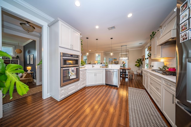 1726 Winfield Way, Charleston, SC 29414 - kitchen featuring appliances with stainless steel finishes, a peninsula, light countertops, white cabinets, and crown molding