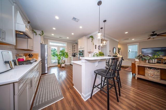 1726 Winfield Way, Charleston, SC 29414 - kitchen featuring stainless steel appliances, ornamental molding, dark wood finished floors, a breakfast bar, and a peninsula