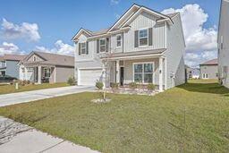 view of front of home with a garage and a front yard