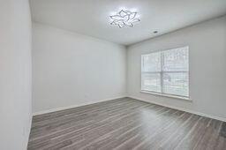 unfurnished room with dark hardwood / wood-style flooring