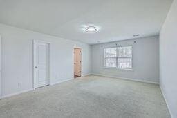 empty room with light colored carpet