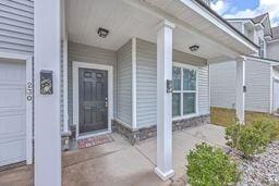 view of exterior entry with a porch