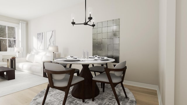 dining space featuring a chandelier, wood finished floors, and baseboards