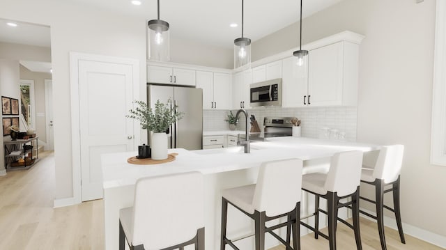 kitchen with stainless steel appliances, tasteful backsplash, a peninsula, and light countertops