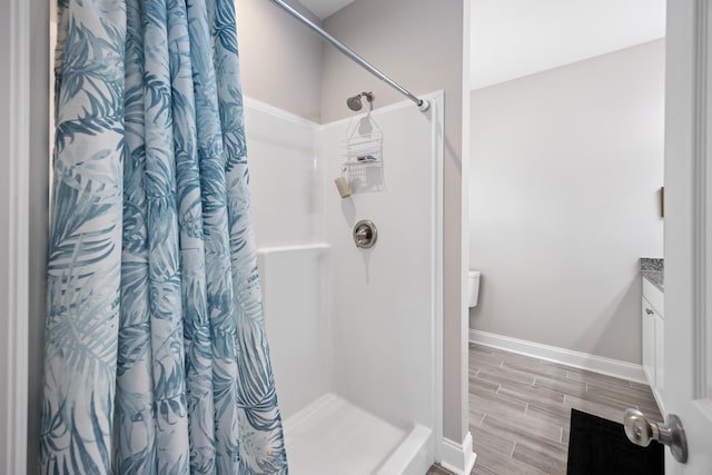 bathroom featuring walk in shower and vanity