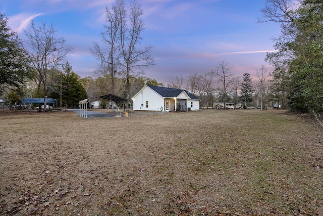 yard at dusk with a carport